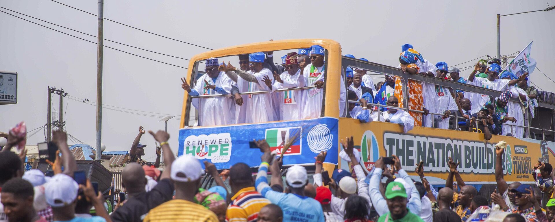 Bola Ahmed Tinubu, foreground right, presidential candidate of the All Progressives Congress, Nigeria ruling party, rides on a double decker bus during an election campaign rally in Lagos Nigeria, Tuesday, Feb 21, 2023.  - Sputnik International, 1920, 29.03.2023