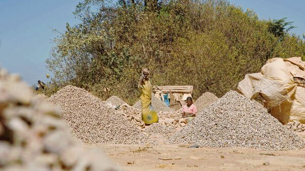 Women workers stand among rocks extracted from a cobalt mine at a copper quarry and cobalt pit in Lubumbashi on May 23, 2016 - Sputnik International