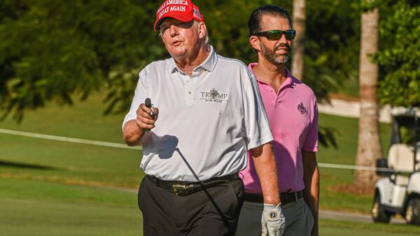 Former US President Donald Trump and his son, Donald Trump, Jr., play golf at Trump National Doral Miami golf club on October 27, 2022 in Miami, Florida - Sputnik International