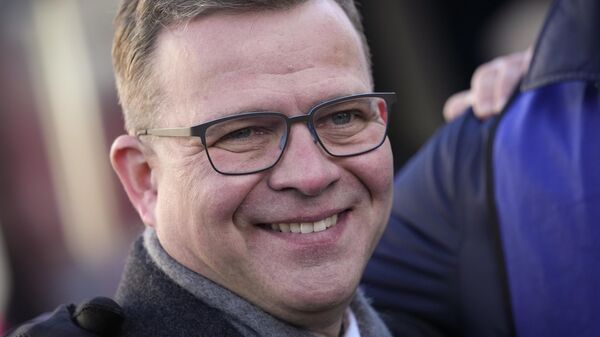 Chairman of the National Coalition Party Petteri Orpo smiles as he meets supporters during a campaign rally in Espoo, Finland, Saturday, April 1, 2023. A parliamentary election in Finland on Sunday is shaping up as an extremely close race between three parties as Prime Minister Sanna Marin's Social Democrats fight to secure a second term running the government.  - Sputnik International