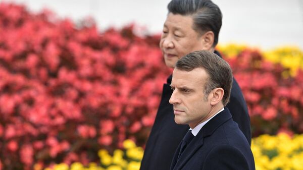French President Emmanuel Macron walks with Chinese President Xi Jinping during a welcome ceremony at the Great Hall of the People in Beijing, in November 2019. - Sputnik International