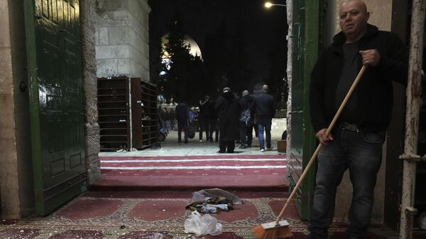A Palestinian worshipper sweeps debris after a raid by Israeli police at the Al-Aqsa Mosque - Sputnik International