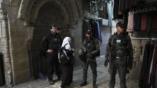 A Muslim woman passes Israeli police at a checkpoint outside of the Al-Aqsa Mosque compound - Sputnik International