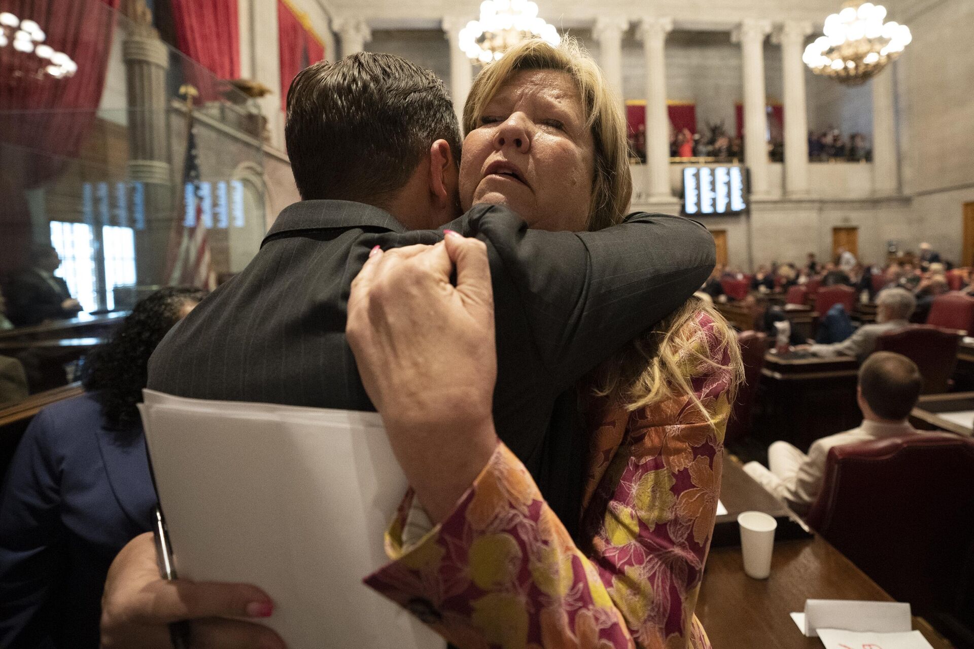 Rep. Gloria Johnson, D-Knoxville, receives a hug from Rep. John Ray Clemmons, D-Nashville, on the floor of the House chamber after a resolution to expel Johnson from the legislature failed on Thursday, April 6, 2023, in Nashville, Tenn. Tennessee Republicans were seeking to oust three House Democrats including Johnson for using a bullhorn to shout support for pro-gun control protesters in the House chamber.  - Sputnik International, 1920, 07.04.2023