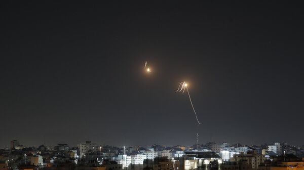 Streaks of light are seen as Israel's Iron Dome air defence system intercepts rockets fired from the Gaza Strip into Israeli territory on April 7, 2023. - Sputnik International
