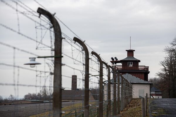 A barbed wire fence encloses the memorial site of the former Buchenwald Nazi concentration camp near Weimar, Eastern Germany. - Sputnik International