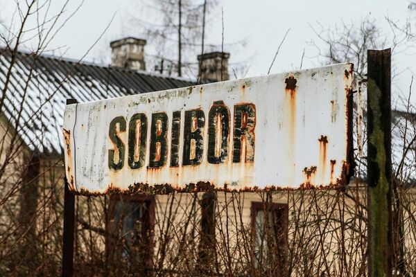 A sign indicating the Sobibor train station near the death camp. - Sputnik International