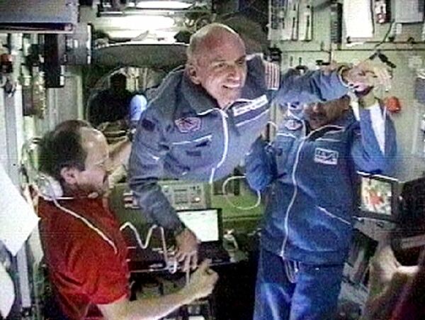 Space station commander Yuri Usachev, left, welcomes California millionaire Dennis Tito, center, and Russian cosmonaut Talgat Musabayev, right, to the International Space Station, in this image from television. Dennis Tito is an American engineer and entrepreneur who is most famous for being the first space tourist. In 2001, he spent eight days on board the International Space Station after paying $20 million for the experience. - Sputnik International