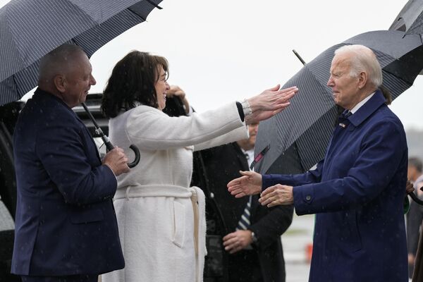 President Joe Biden greets US Ambassador to Ireland Claire Cronin and her spouse Ray, left, as he arrives at Dublin International Airport in the Irish capital. - Sputnik International