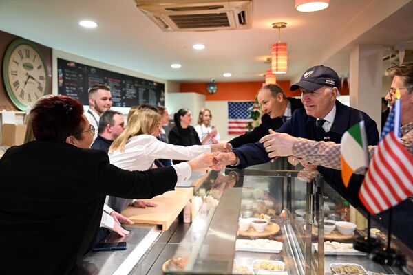 US President Joe Biden (R) and Ireland&#x27;s Minister of Foreign Affairs Micheal Martin (rear R) meet with members of the public at the McAteers Food House during a tour of downtown Dundalk as part of a four-days trip to Northern Ireland and Ireland for the 25th anniversary commemoration of the &#x27;Good Friday Agreement&#x27;. - Sputnik International