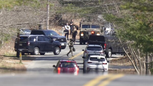 Members of law enforcement assemble on a road, Thursday, April 13, 2023, in Dighton, Mass., near where FBI agents converged on the home of a Massachusetts Air National Guard member who has emerged as a main person of interest in the disclosure of highly classified military documents on the Ukraine. The guardsman was identified as 21-year-old Jack Teixeira. - Sputnik International
