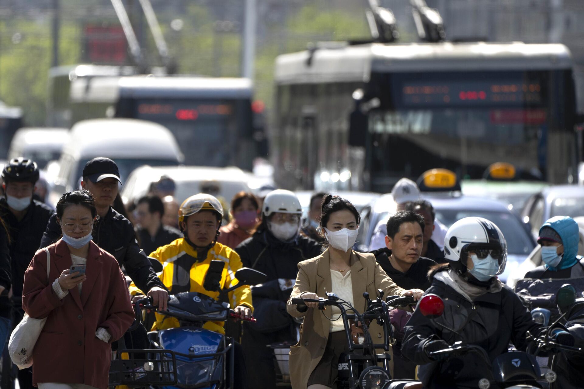 Commuters cross an intersection in the central business district during the morning rush hour in Beijing, Tuesday, April 18, 2023. - Sputnik International, 1920, 18.04.2023