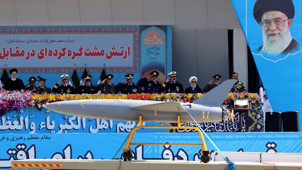 An Iranian rocket-powered drone passes the podium in Tehran as President Ebrahim Raisi and high-ranking officials and commanders look on. April 18, 2023. - Sputnik International