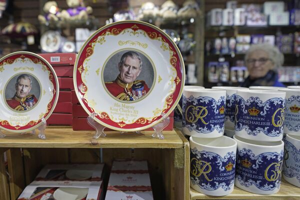 Coronation plates and cups are displayed for sale in a gift shop in London on Monday.  - Sputnik International