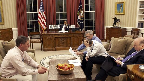Obama on the phone while, deputy national security advisor Denis McDonough, speech writer Ben Rhodes, and national security advisor Tom Donilon sit on the right couch. The man on the left couch is unidentified. - Sputnik International