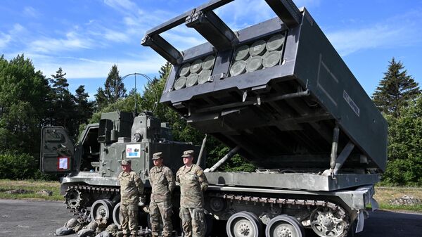 Soldiers the British Army's 1st Royal Horse Artillery stand in front of an armored, self-propelled, Multiple Launch Rocket System (M270 MLRS) during the 'Dynamic Front 22', the US Army led NATO and Partner integrated annual artillery exercise in Europe, in Grafenwoehr, near Eschenbach, southern Germany, on July 20, 2022 - Sputnik International