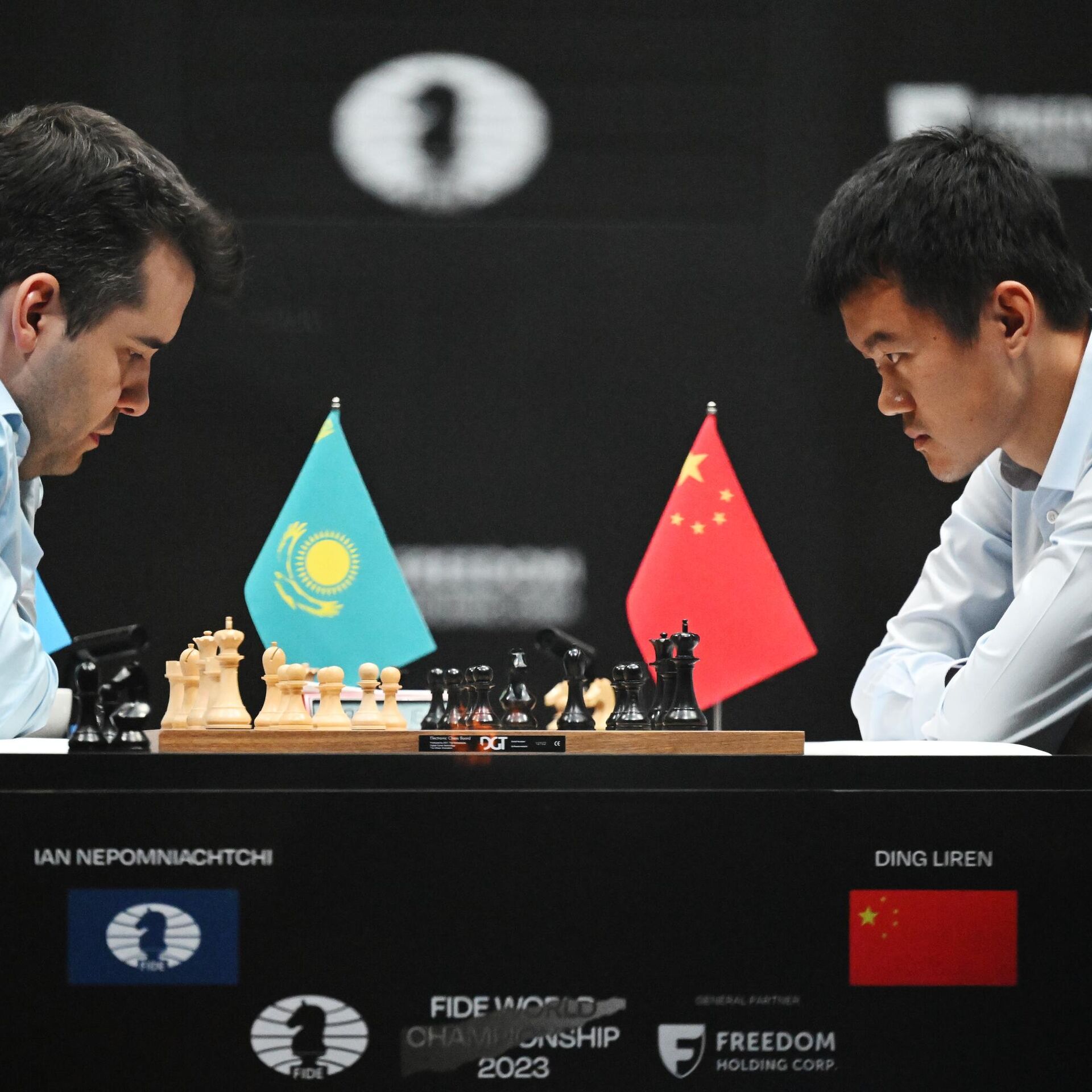 China's Ding Liren, left, and Russia's Ian Nepomniachtchi shake hands prior  to their FIDE World Chess Championship in Astana, Kazakhstan, Saturday,  April 29, 2023. Ian Nepomniachtchi and Ding Liren are facing off