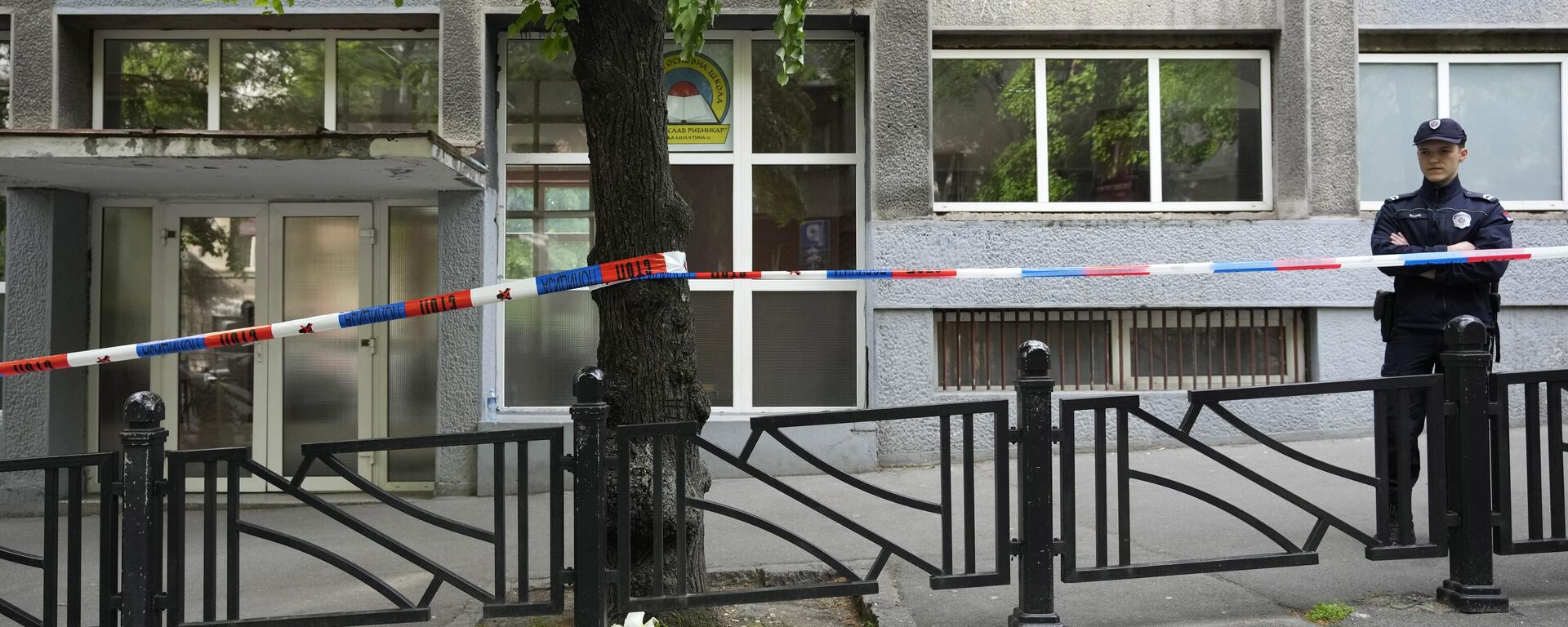 Policeman stands in front of the Ribnikar school in Belgrade, Serbia, Wednesday, May 3, 2023. Police say a 13-year-old who opened fire at his school drew sketches of classrooms and made a list of people he intended to target. He killed eight fellow students and a school guard before being arrested Wednesday. - Sputnik International, 1920, 03.05.2023