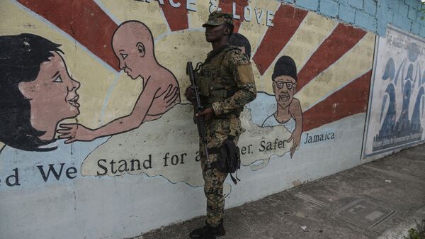 A soldier stands guard at a checkpoint in the August Town community of Kingston, Jamaica, Wednesday, Dec. 7, 2022. Jamaica’s prime minister declared a widespread state of emergency Tuesday, Dec. 6, to fight a surge in gang violence on an island with one of the highest murder rates in the region. - Sputnik International