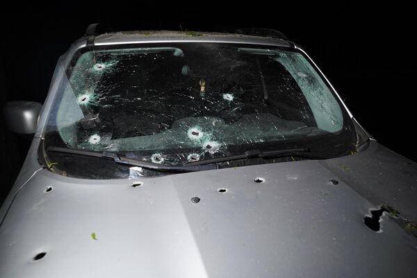Vehicle damaged after Ukrainian shelling of Gorlovka - Sputnik International