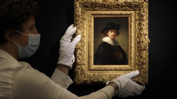 A Sotheby's employee adjusts a painting by Rembrandt Van Rijn called 'Self-portrait, wearing a ruff and black hat' at Sotheby's auction rooms in London, Thursday, July 23, 2020. - Sputnik International