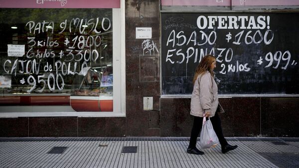 A woman walks by a meat market in Buenos Aires, Argentina, Thursday, May 11, 2023. According to a recent World Bank Food Security report, Argentina has seen a 107% annual inflation rate in food prices. - Sputnik International