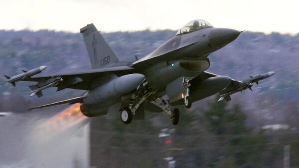 In this Dec. 2001 file photograph, an F-16 takes off with afterburners glowing loaded with live Sidewinder missiles from the Air National Guard base in South Burlington, Vt. - Sputnik International