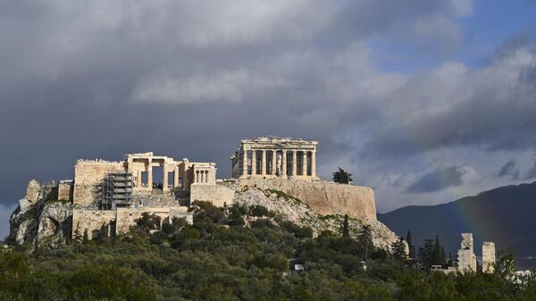 This photograph taken in Athens on February 8, 2022 shows a rainbow appearing over the Ancient Acropolis. - Sputnik International