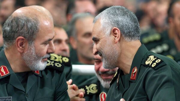 An undated handout picture obtained from the office of Iran's Supreme Leader Ayatollah Ali Khamenei on May 22, 2023, shows Revolutionary Guards general Ali Akbar Ahmadian (L) speaking with slain Iranian Major-General Qasem Soleimani during a meeting in Tehran. Iran's President Ebrahim Raisi on May 22 appointed Ahmadian as the new secretary of the Supreme National Security Council, replacing longtime chief and leading Gulf mediator Ali Shamkhani. - Sputnik International