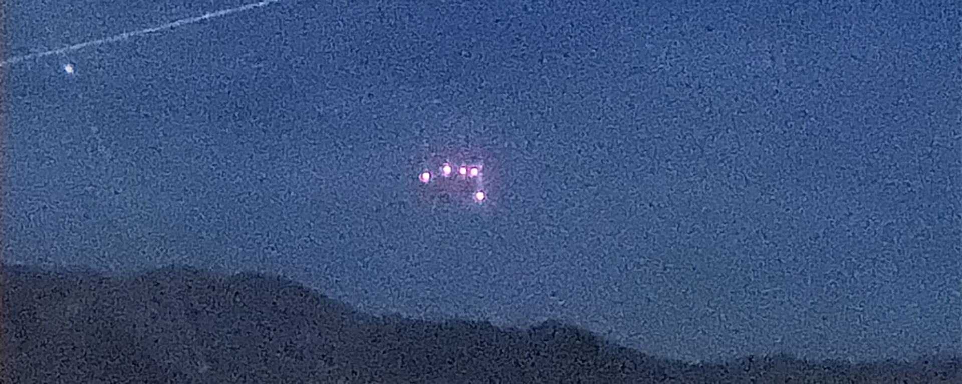 A purported UFO spotted over Marine Corps Air Ground Combat Center Twentynine Palms in April 2021. The photo, taken on a low-light camera, purports to have captured the UFO's triangular shape. - Sputnik International, 1920, 26.05.2023