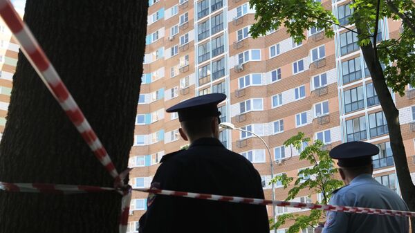 Police officers outside a residential building affected by a drone attack on Profsoyuznaya Street in Moscow.  - Sputnik International