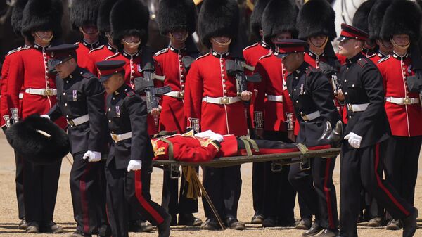 A soldier is carried out on a stretcher after a faint during the Colonel's Review, the final rehearsal of the Trooping the Colour, the King's annual birthday parade, at Horse Guards Parade in London, Saturday, June 10, 2023.  - Sputnik International