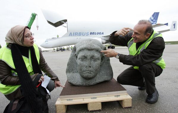 French archaeologist Franck Goddio (R) and Egyptian curator Snaa Fouad Zaki (L) from Cairo&#x27;s Museum, show the statue of Cesarion, upon its arrival aboard a Beluga plane from Cairo, at Roissy airport, near Paris, 16 November 2006. The black granite statue, shown in Paris museum, le Grand Palais  in the exhibition &quot;Tresors engloutis d&#x27;Egypte&quot; (Egyptian immersed treasures), from 09 December 2006 to 14 March 2007, was found at the port of Alexandria by Goddio. Ptolemee XV, better known as Cesarion, is the illegal son of Cleopatra, Queen of Egypt (from -51 to -30 before J.C) and was killed by Roman Emperor Octavius.  - Sputnik International