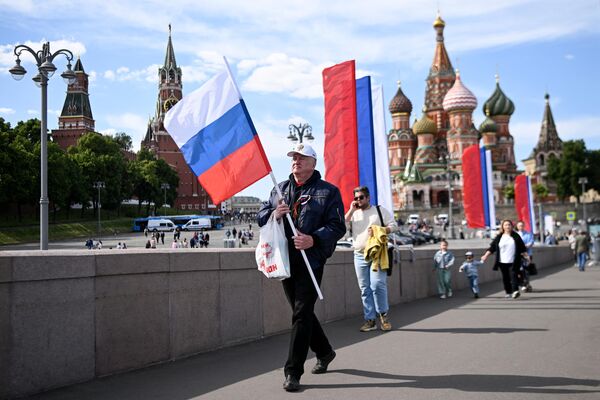 While Russia Day is celebrated since the 1990s, the first Russia Day event at the Red Square in Moscow was held only in 2003.Above: A man carries a Russian national flag as he leaves the patriotic concert at the Red Square, near the Kremlin, in downtown Moscow ahead the Russia Day on June 11, 2023. - Sputnik International