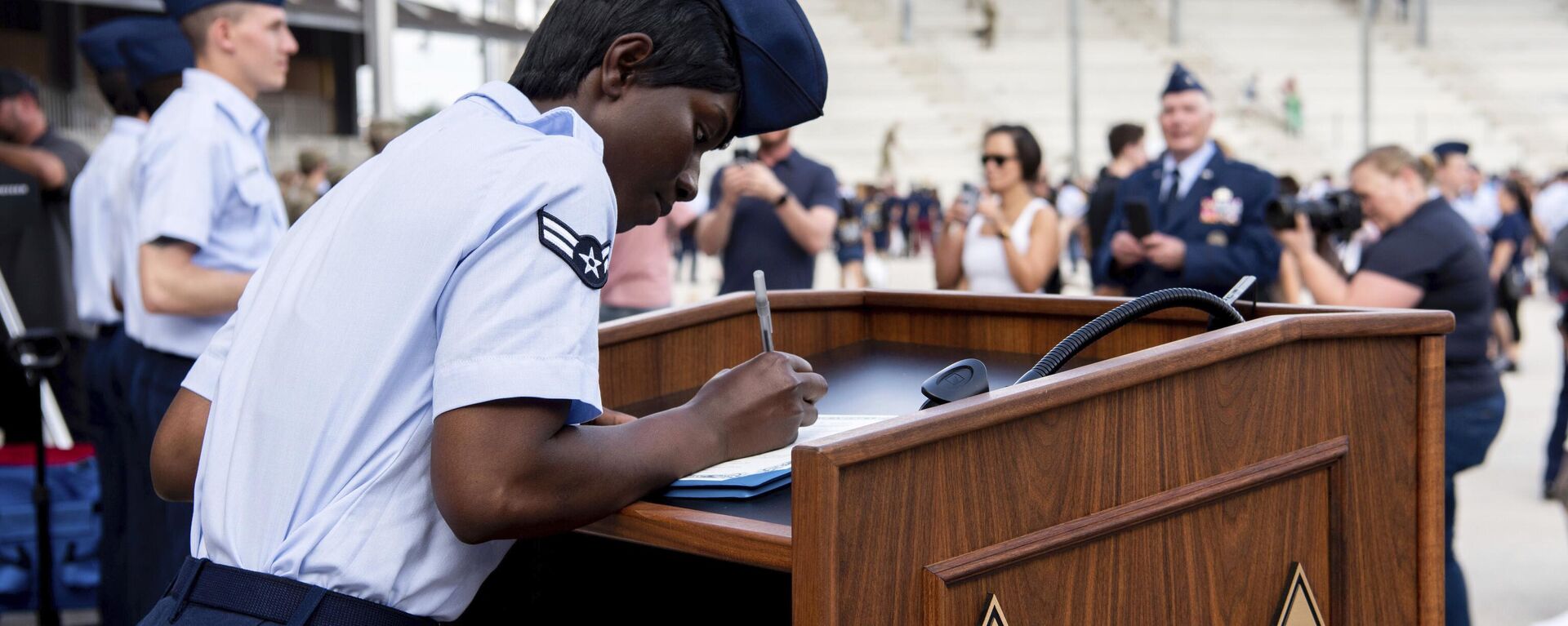 Airman 1st Class D'elbrah Assamoi, from Cote D'Ivoire, signs her US certificate of citizenship after the Basic Military Training Coin Ceremony at Joint Base San Antonio-Lackland, in San Antonio, April 26, 2023 - Sputnik International, 1920, 12.06.2023