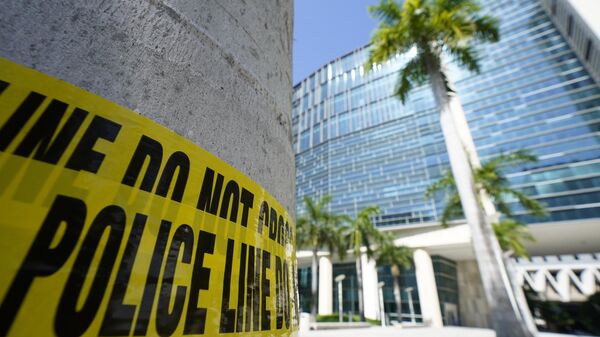 Police tape is wrapped around a palm tree outside the Wilkie D. Ferguson Jr. U.S. Courthouse, Monday, June 12, 2023, in Miami, Fla. Former President Donald Trump is set to appear at the federal court Tuesday, on dozens of felony charges accusing him of illegally hoarding classified information. - Sputnik International