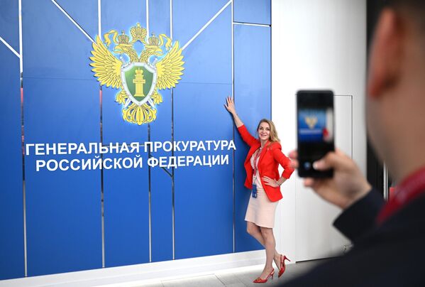 A forum participant having her picture taken at the stand of the Russian Prosecutor General&#x27;s Office at the St. Petersburg International Economic Forum. - Sputnik International
