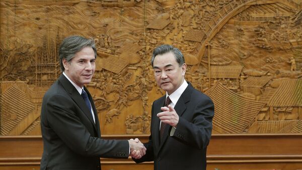 Then-US Deputy Secretary of State Antony Blinken (L) shakes hand with Chinese Foreign Minister Wang Yi at the Olive Hall before a meeting at the Foreign Ministry office in Beijing on February 11, 2015.  - Sputnik International