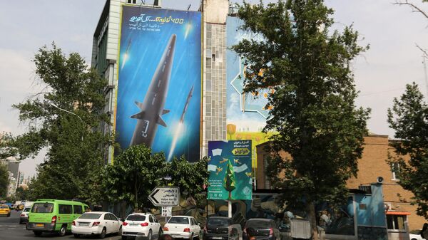A giant billboard bearing a picture of the 'Fattah' hypersonic missile, covers the side of a building in Tehran on July 7, 2023. - Sputnik International