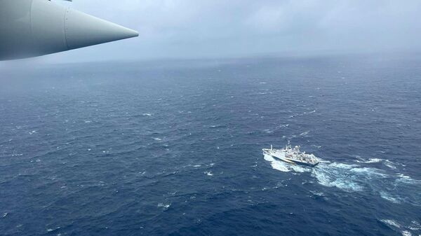 In this image provided by the U.S. Coast Guard, a Coast Guard HC-130 Hercules airplane based at Coast Guard Air Station Elizabeth City, N.C., flies over the French research vessel, L'Atalante approximately 900 miles East of Cape Cod, Mass., during the search for the 21-foot submersible, Titan, Wednesday, June 21, 2023. - Sputnik International