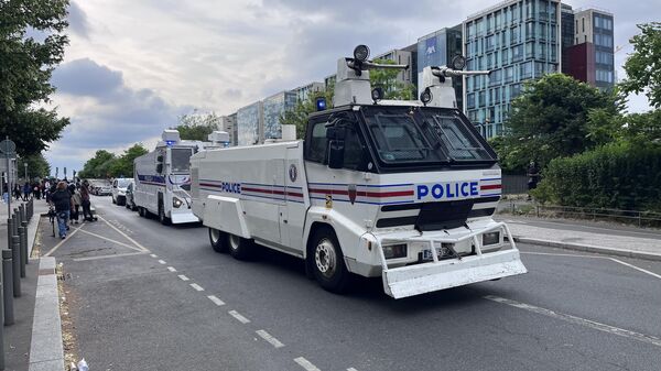 Police anti-riot vehicles are seen on a street during protests after the death of Nahel, a 17-year-old teenager killed by a French police officer during a traffic stop, in Nanterre, Paris suburb, France. - Sputnik International