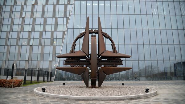 The NATO logo in front of the headquarters of the North Atlantic Treaty Organization in Brussels - Sputnik International