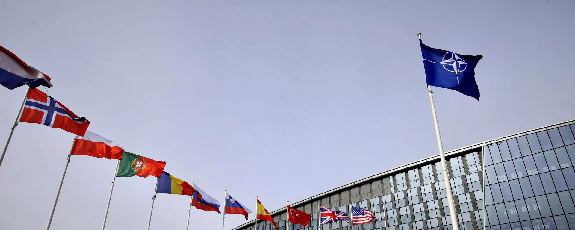 Flags of Alliance members flap in the wind outside NATO headquarters in Brussels, Friday, Feb. 28, 2020. (AP Photo/Olivier Matthys) - Sputnik International, 1920, 25.11.2024