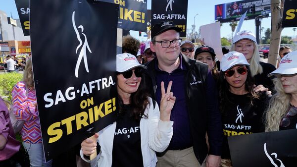 SAG-AFTRA president Fran Drescher from left, Duncan Crabtree-Ireland, SAG-AFTRA national executive director and chief negotiator, and actor Frances Fisher, at far right, take part in a rally by striking writers and actors outside Netflix studio in Los Angeles on Friday, July 14, 2023. This marks the first day actors formally joined the picket lines, more than two months after screenwriters began striking in their bid to get better pay and working conditions.  - Sputnik International