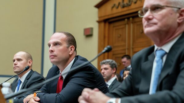 Ryan Graves, Americans for Safe Aerospace Executive Director, from left, U.S. Air Force (Ret.) Maj. David Grusch, and U.S. Navy (Ret.) Cmdr. David Fravor, testify before a House Oversight and Accountability subcommittee hearing on UFOs, Wednesday, July 26, 2023, on Capitol Hill in  Washington. (AP Photo/Nathan Howard) - Sputnik International