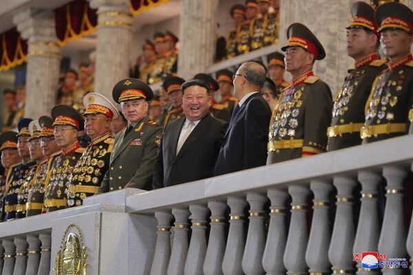 Russian Defense Minister Sergei Shoigu and North Korean leader Kim Jong-un are standing on the balcony watching the parade. - Sputnik International