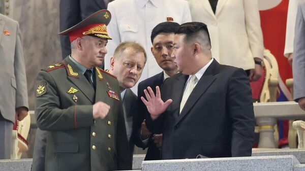 Russian Defense Minister Sergei Shoigu is seen talking to North Korean leader Kim Jong Un. - Sputnik International