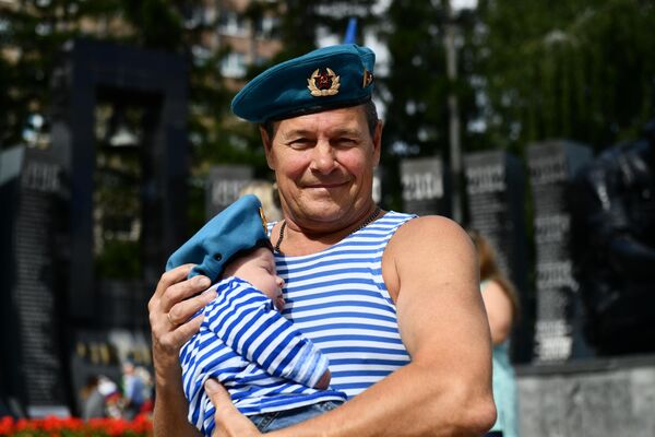 A paratrooper with a child at the Black Tulip memorial in Yekaterinburg on Airborne Forces Day. - Sputnik International
