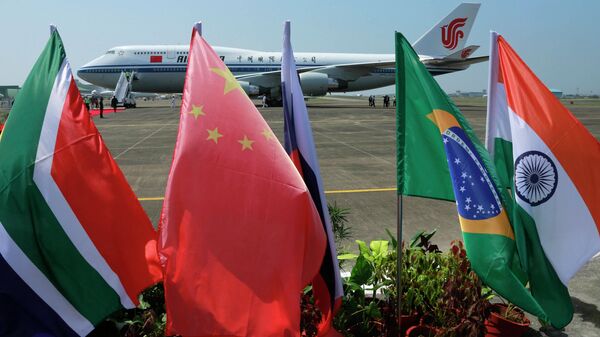 Flags of the five countries that make up BRICS fly in front of an Air China aircraft in which Chinese President Xi Jinping arrived to attend the BRICS summit in Goa, India, Saturday, Oct. 15 2016. - Sputnik International