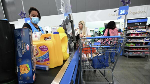 A cashier scans items at a Walmart store in Burbank, California on August 15, 2022. Walmart, the largest retailer the United States, will report second quarter earnings on August 16, 2022. - Sputnik International